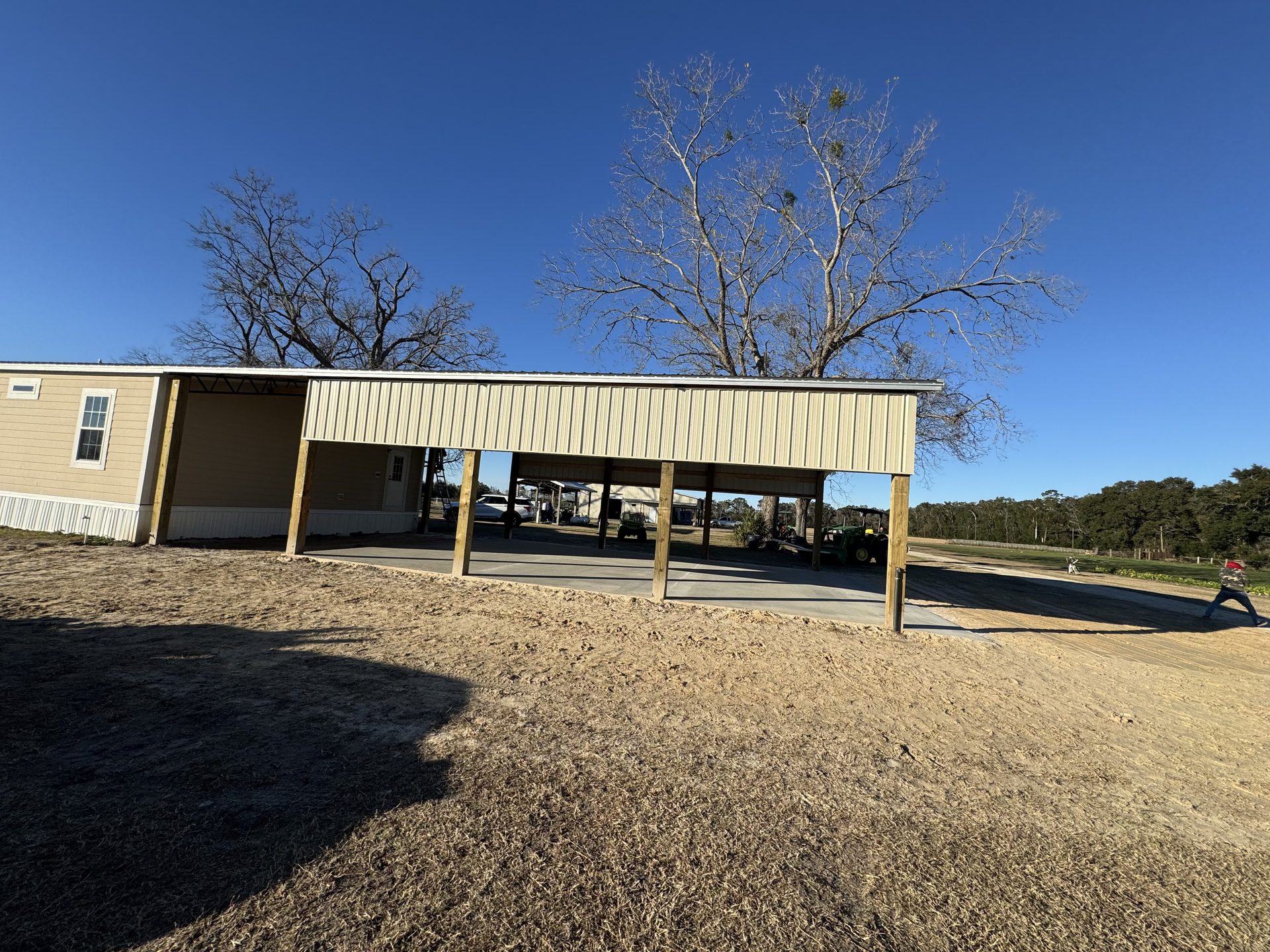 Pole barn construction progress — framing and metal panel installation