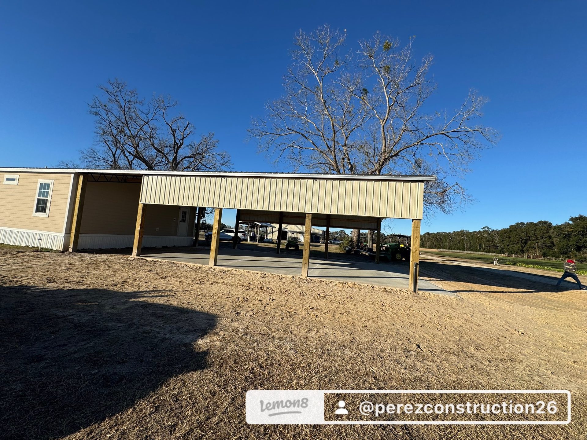 Enclosed pole barn with metal siding and entry doors