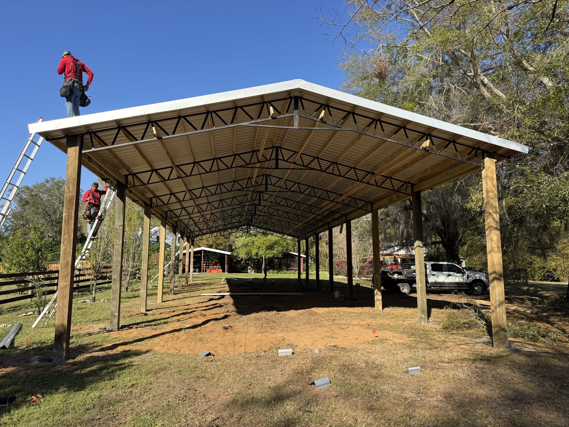 Barndominium build in progress — metal panels being installed