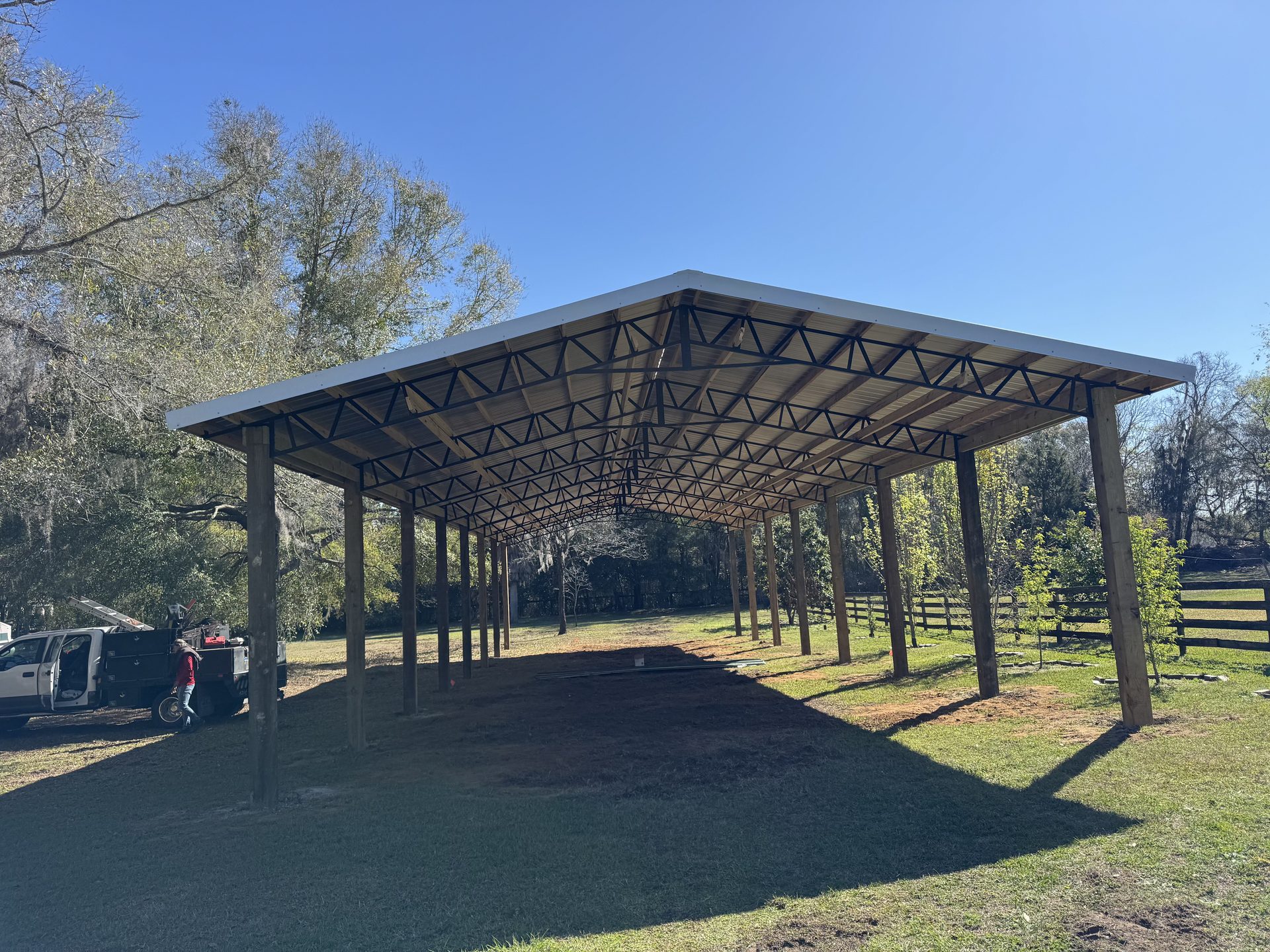 Barndominium exterior with covered porch and treated wood posts