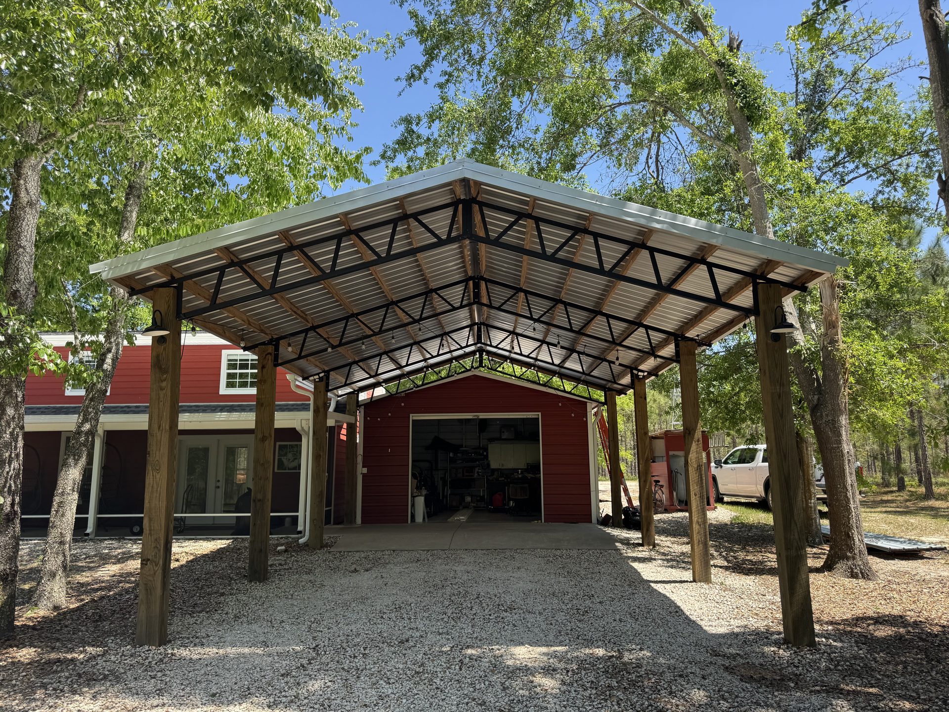 Dark metal pole barn with two roll-up doors on a Florida rural property