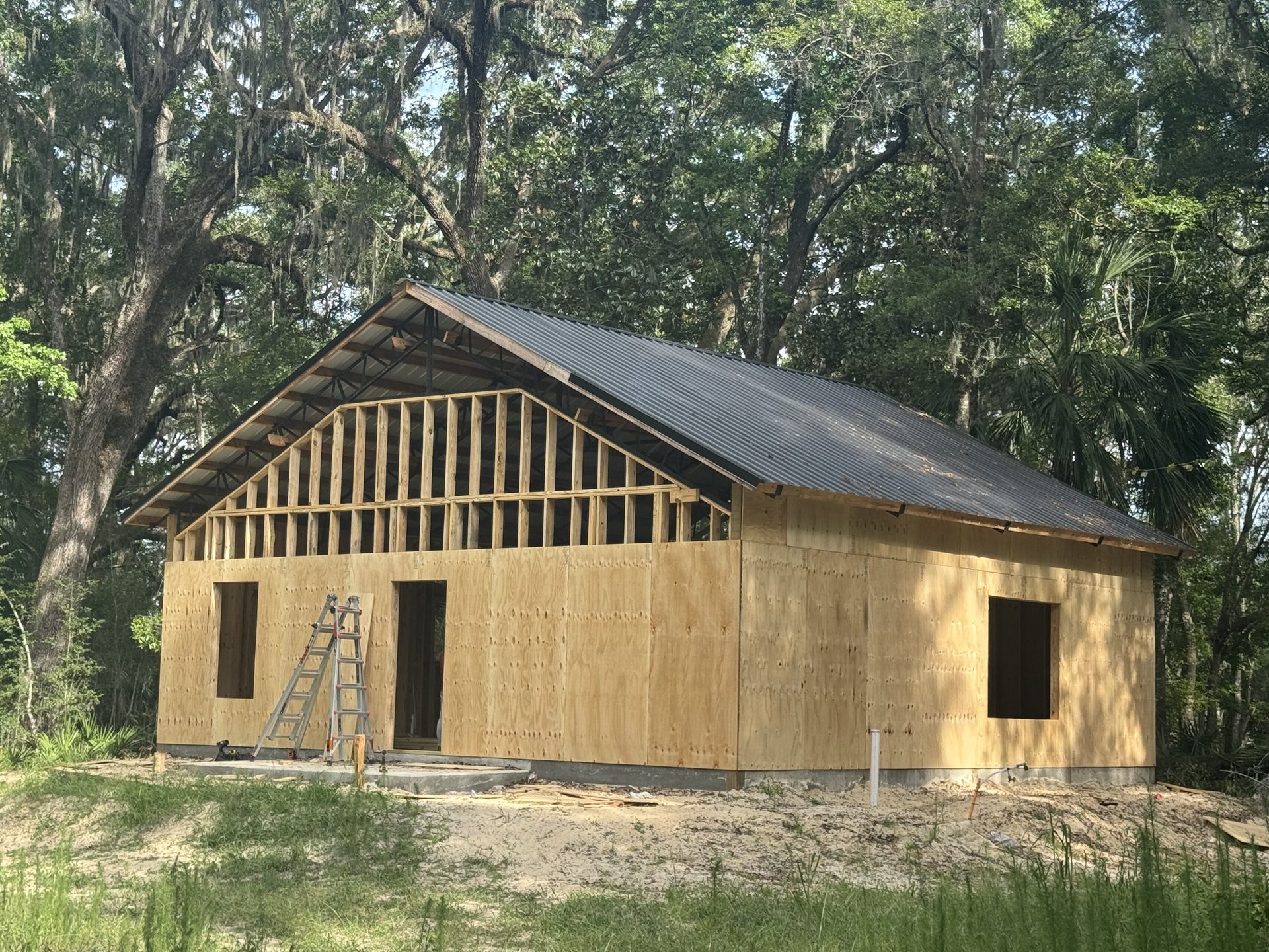 Pole barn structure with metal siding and roof on a clear day