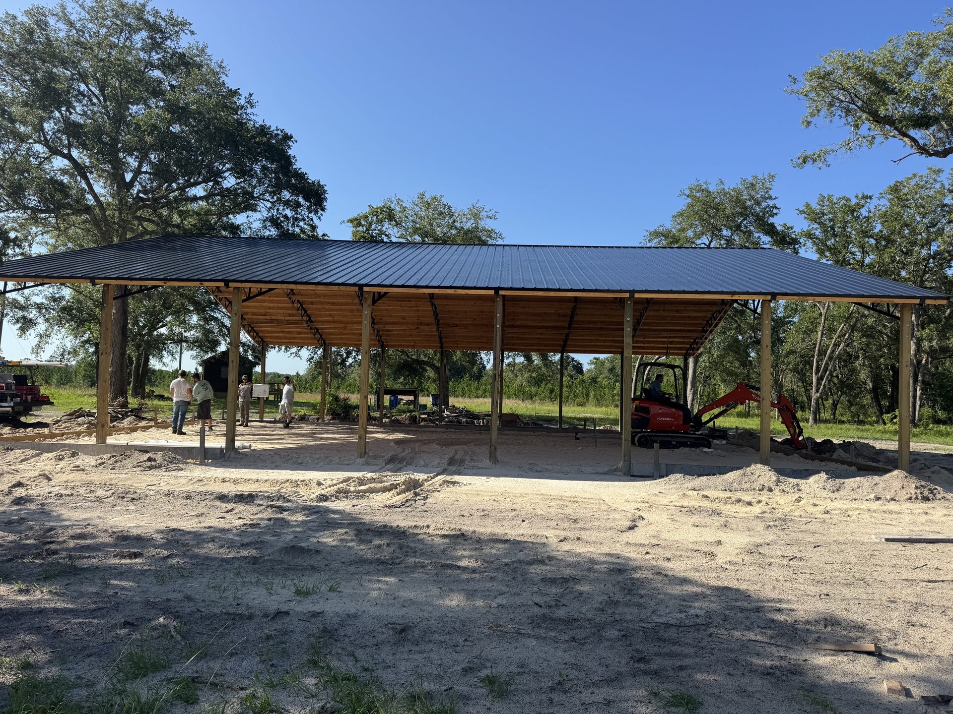 Large pole barn build — exterior metal panel installation in progress