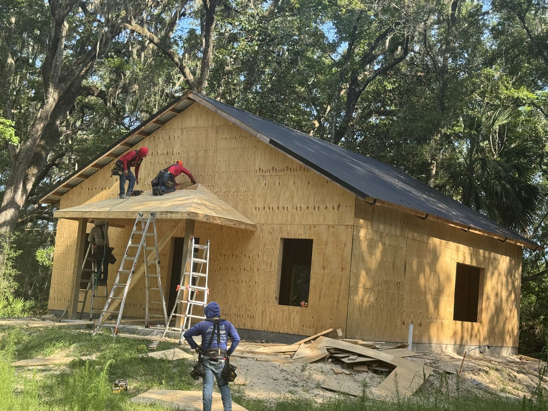 Completed enclosed pole barn with roll-up door on Florida property
