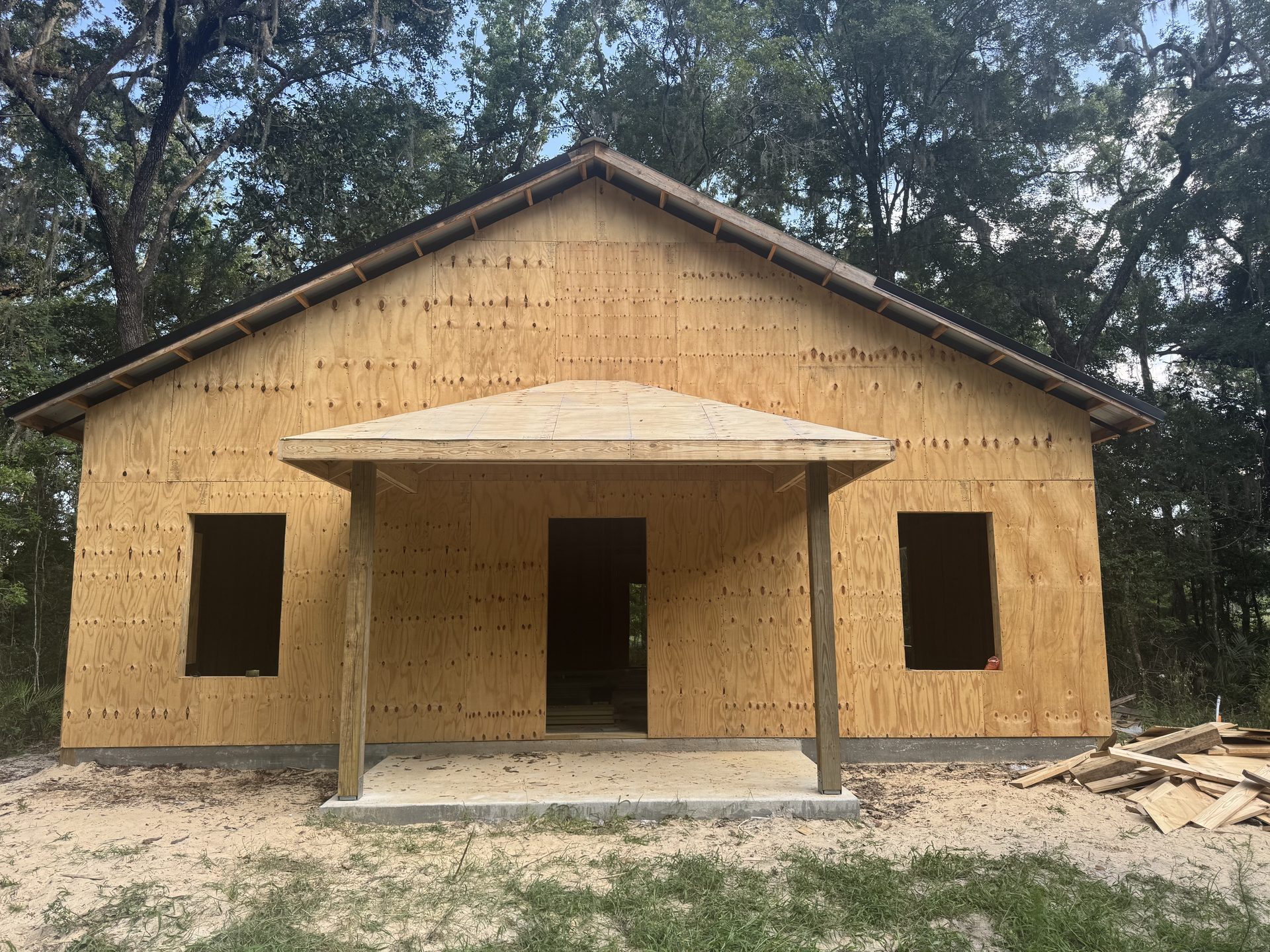 Custom pole barn with covered lean-to and metal roof