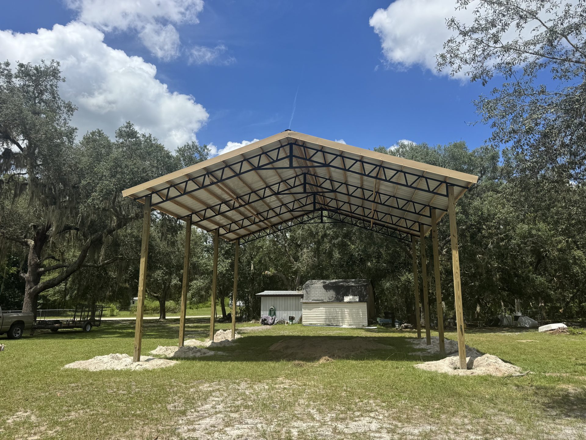 Completed pole barn on cleared Florida lot with gravel drive