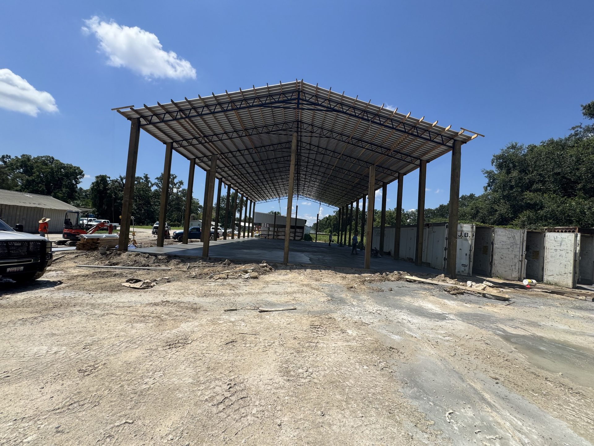 Enclosed pole barn with overhead door and walk-in entry