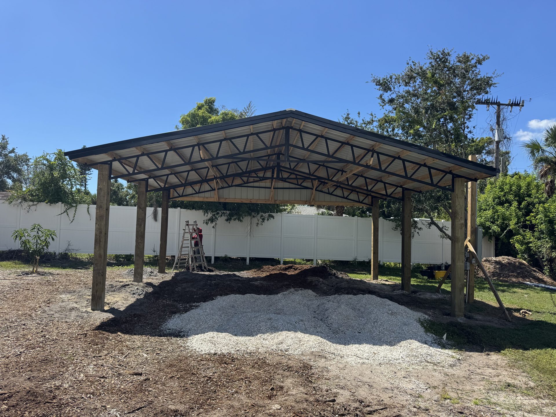 Pole barn under construction with steel truss framing visible