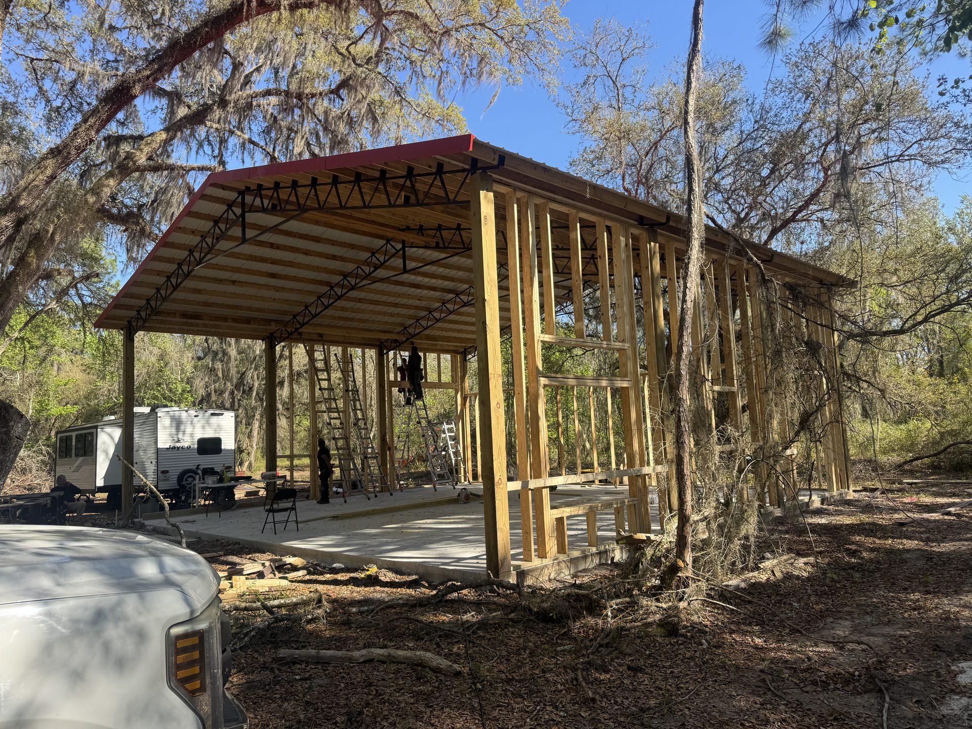Completed enclosed pole barn with metal siding and roof