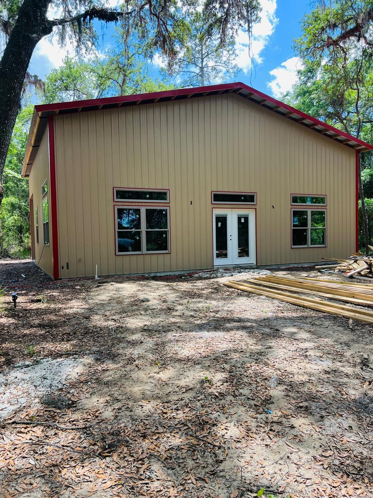 Barndominiums — Tan barndo with red trim