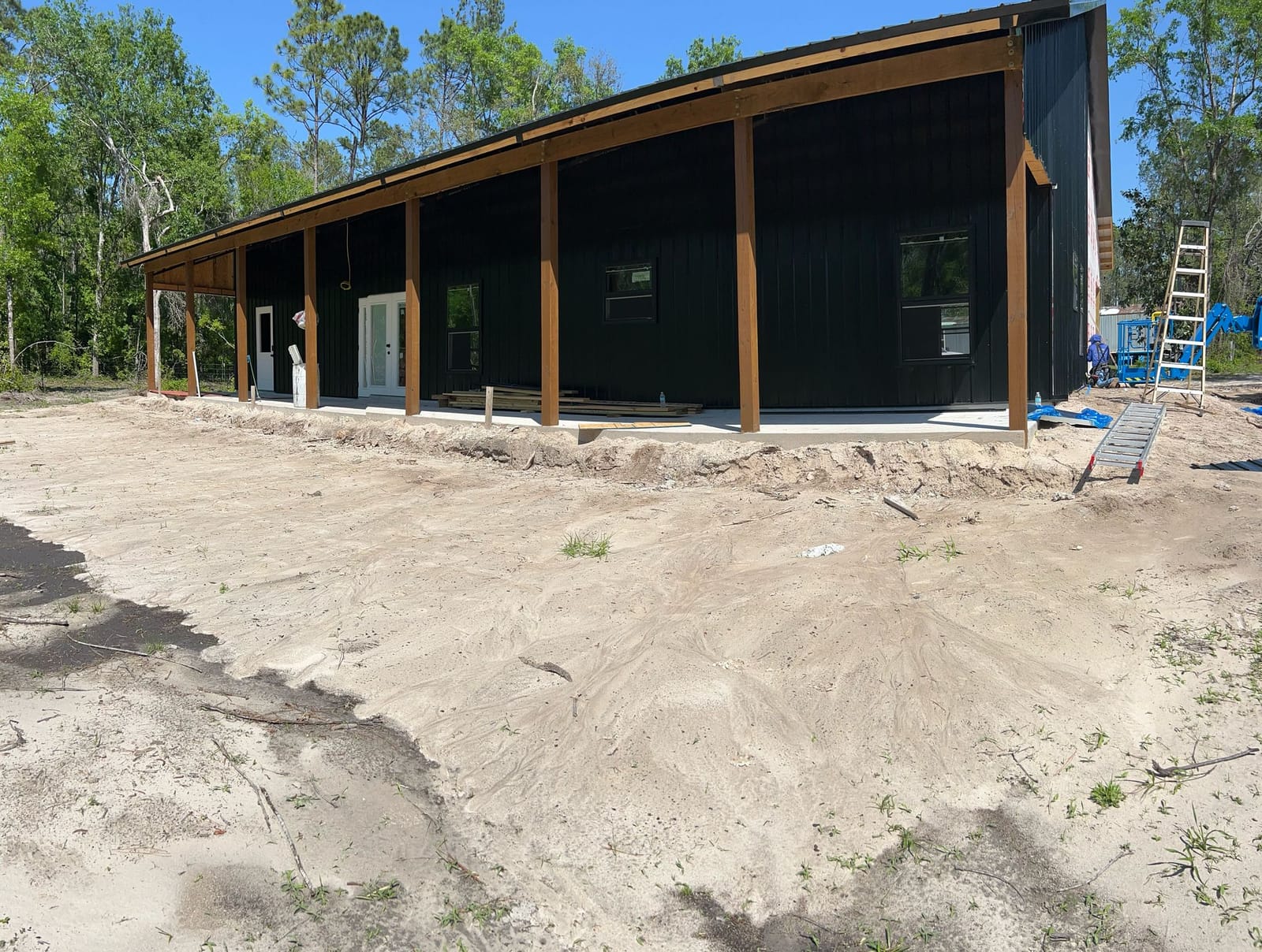 Barndominiums — Black barndo with porch posts