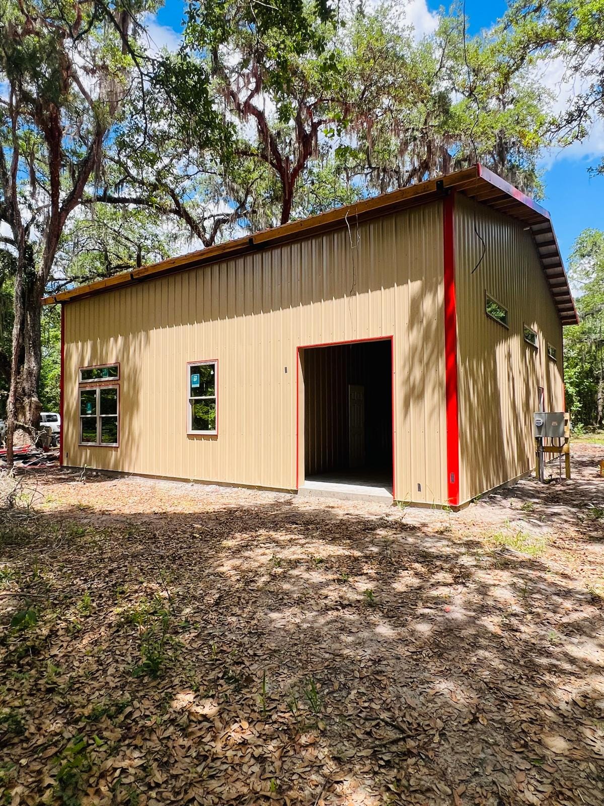 Enclosed Pole Barns — Tan enclosed barn with red trim