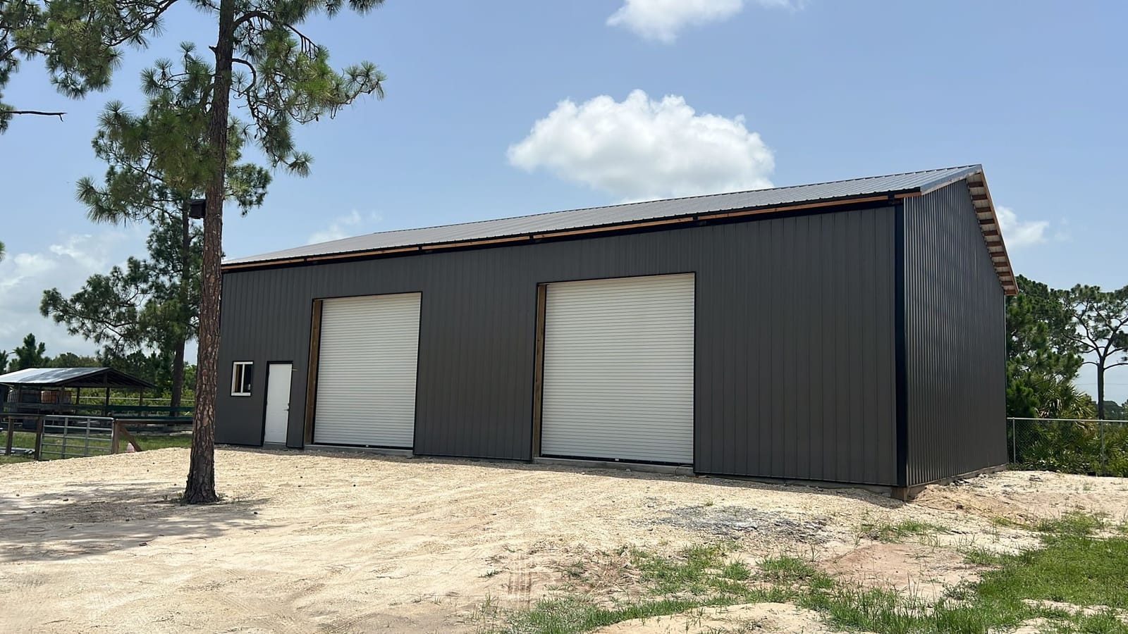 Garages — Black metal garage with roll-ups