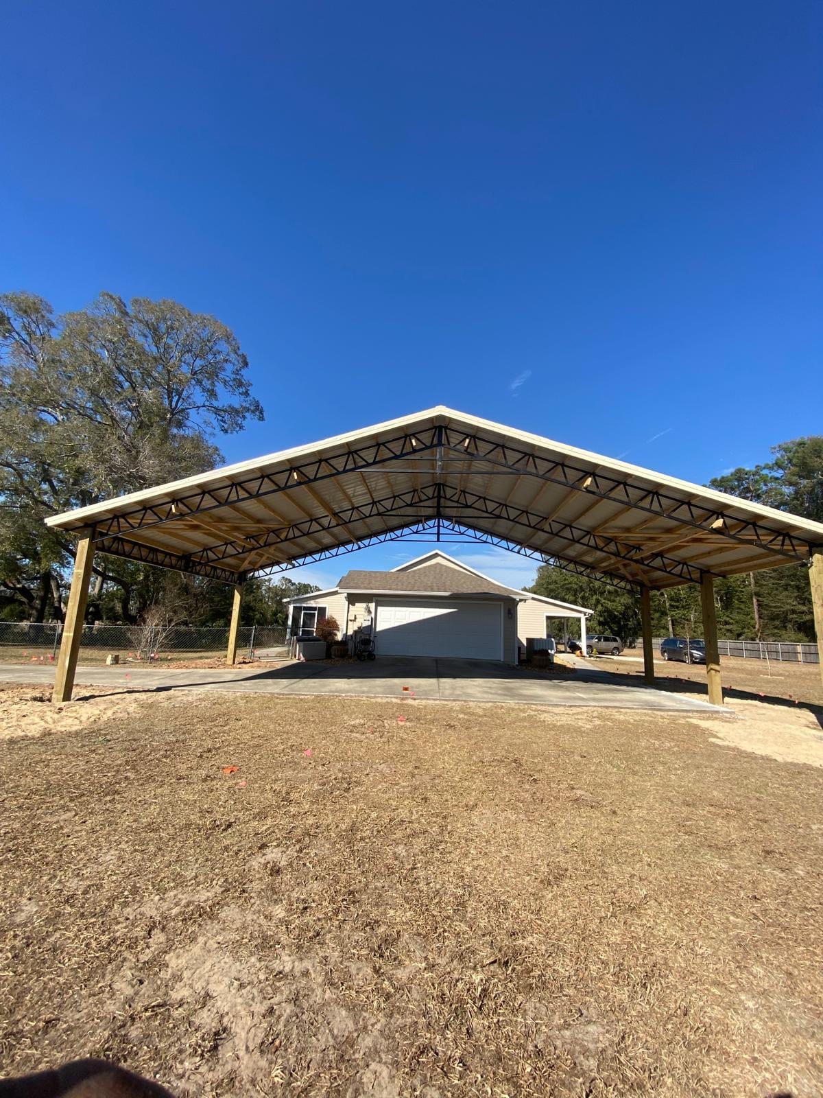 Open Pole Barns — Large open RV cover by garage