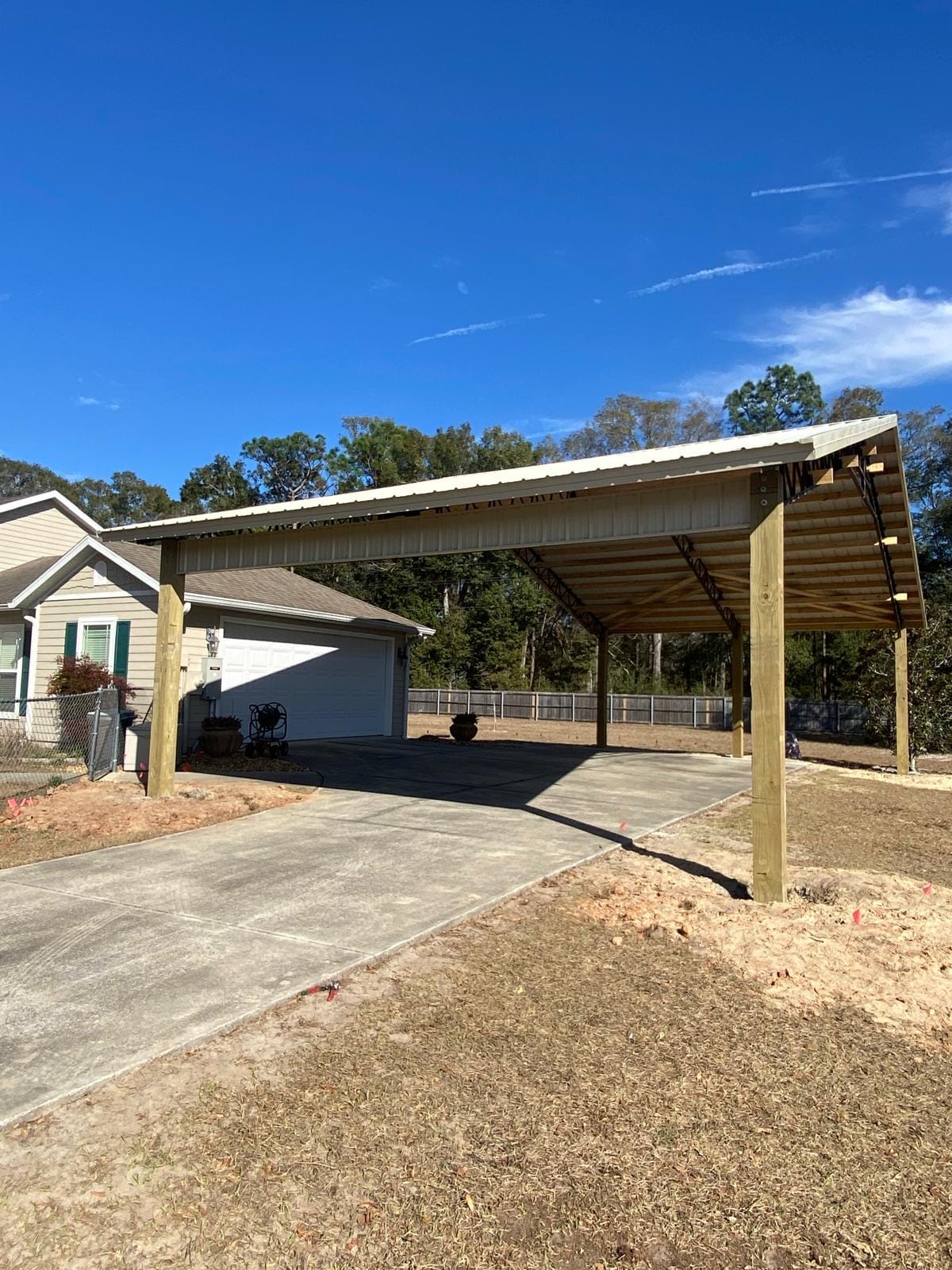 Open Pole Barns — Open carport attached to garage