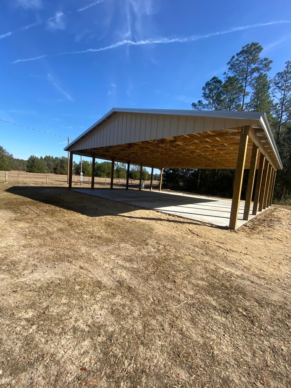 Open Pole Barns — Tan open pole barn shelter